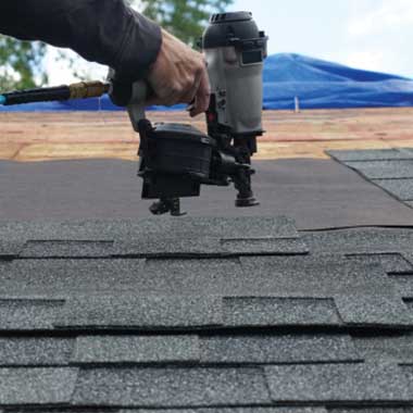 A residential house with a newly installed roof featuring clean, uniform shingles.