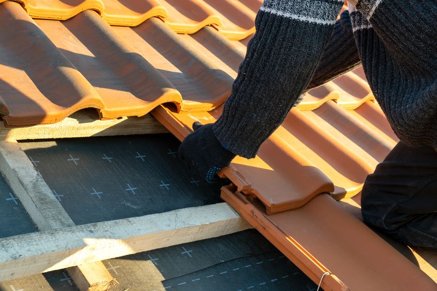 Crew installing a replacement roof