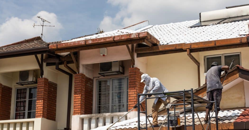 men painting the roof