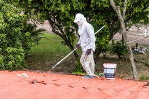 man painting the roof