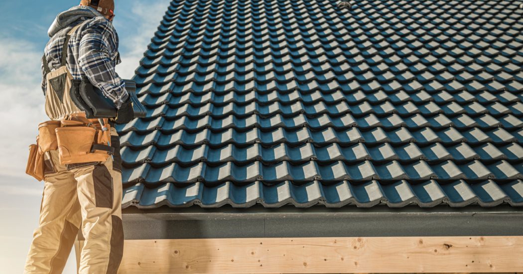 roof worker installing tile roof