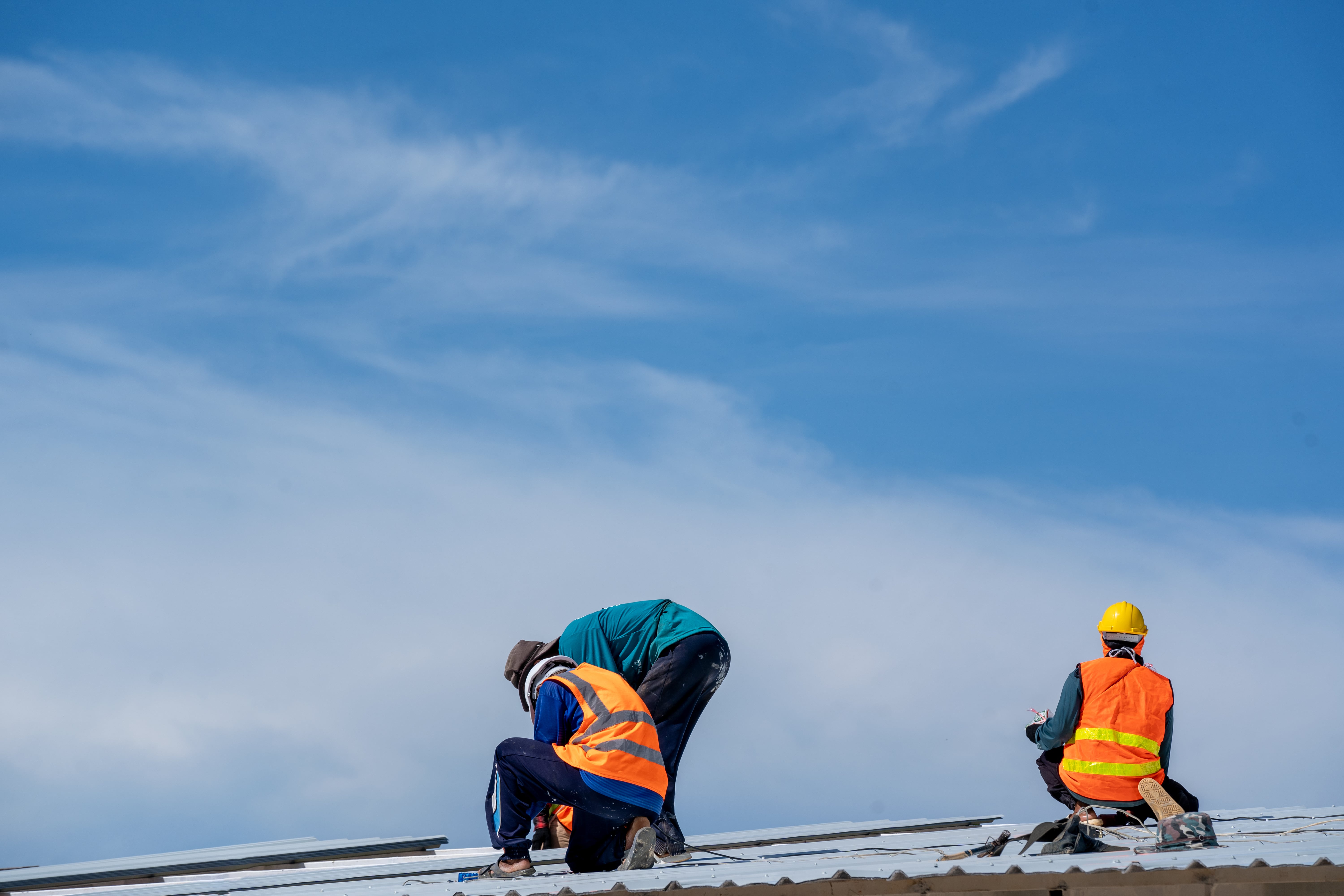 roof workers assessing the roof of a commercial building