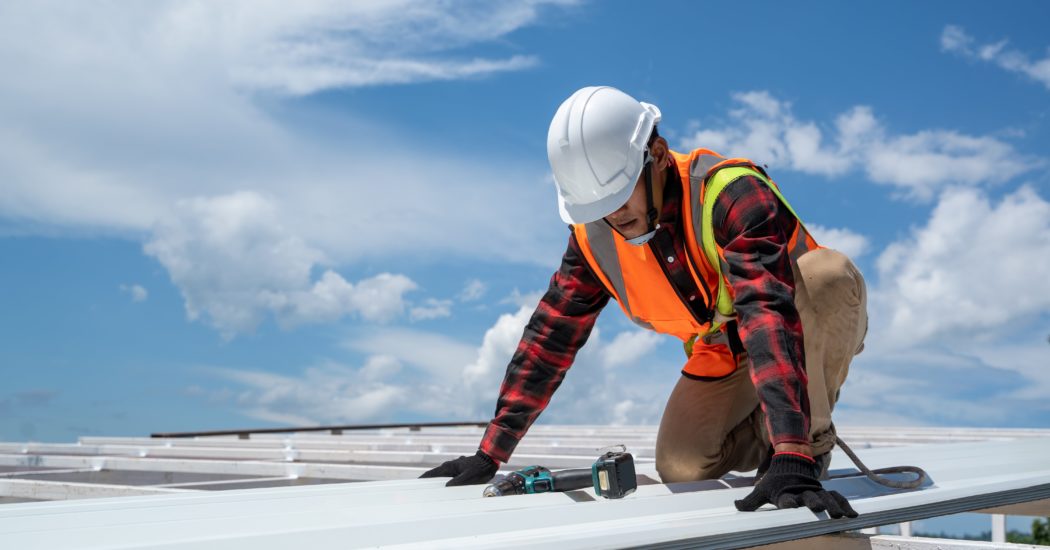 roofing worker installing new roof
