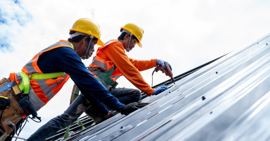 two man repairing roof
