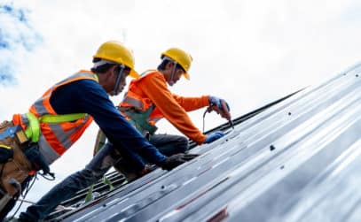 two man repairing roof