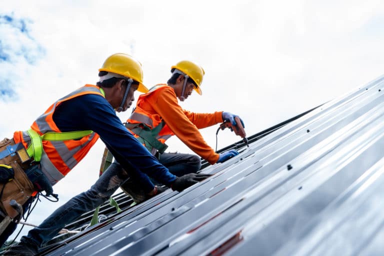 two man repairing roof