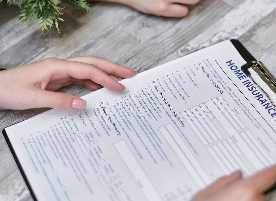 Close-up of hands reviewing a home insurance claim document