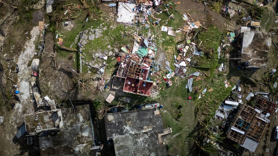 Storm damaged roof showing the type of damage often covered by a homeowners insurance claim